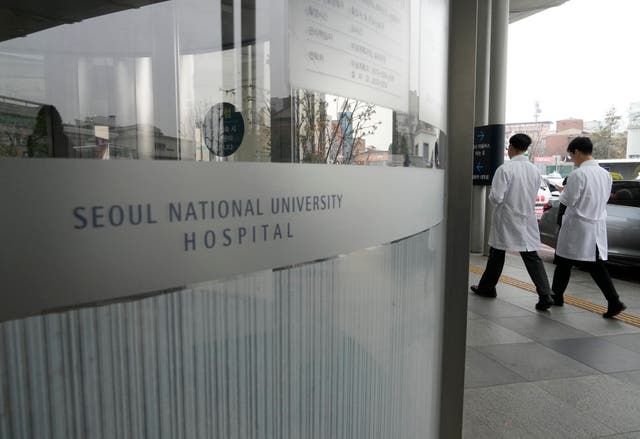 <p>File. Medical workers walk to enter Seoul National University Hospital in Seoul, South Korea, Thursday, 29 February 2024</p>
