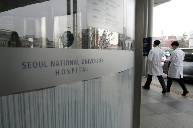 <p>File. Medical workers walk to enter Seoul National University Hospital in Seoul, South Korea, Thursday, 29 February 2024</p>