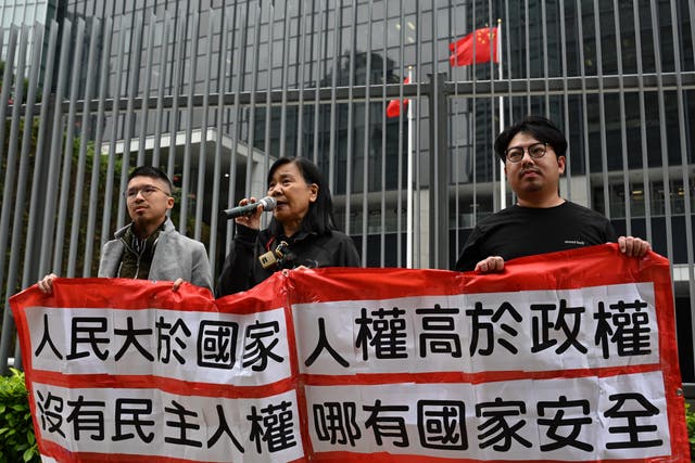 <p>Members of the League of Social Democrats hold up a banner which reads “Without democracy, there can be no livelihood, “Put the people above the country, human rights above the regime, There can be no national security without democracy and human rights.” outside the Central Government offices in Hong Kong  on 27 February</p>