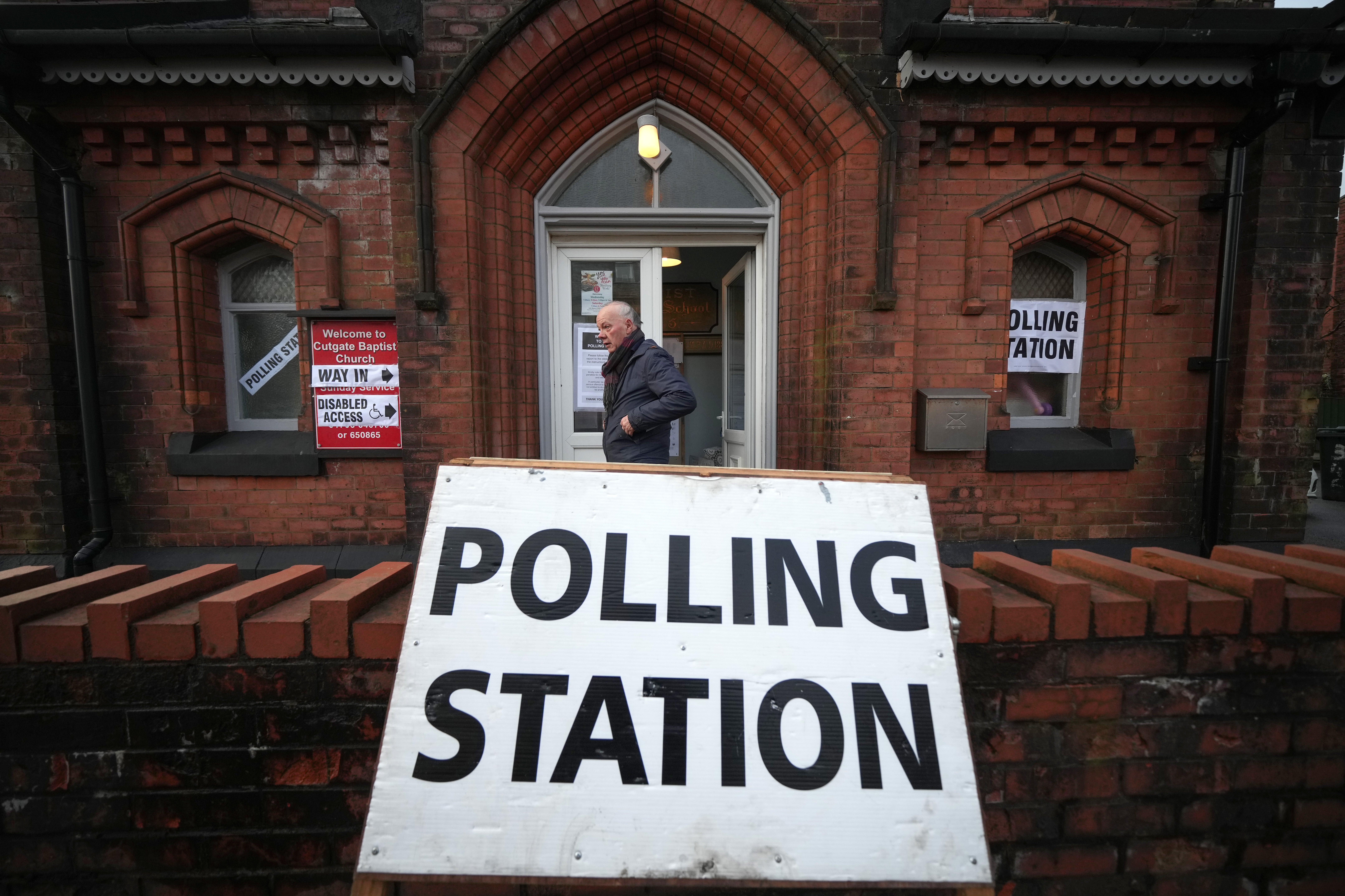 A voter leaves a polling station in Rochdale where the by-election has been marred with controversary