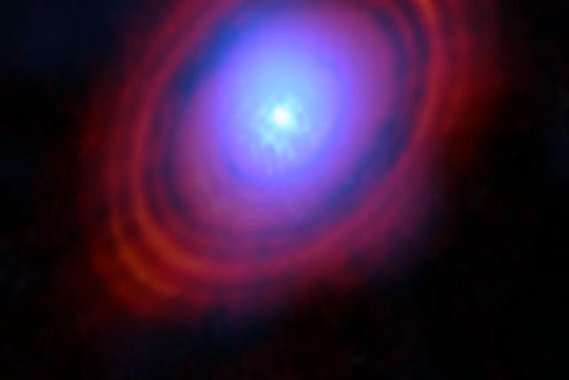 <p>Water vapour discovered in the disc is shown in shades of blue (ALMA/ESO/NAOJ/NRAO/S Facchini et al/PA)</p>