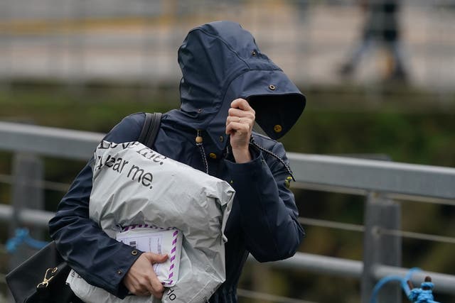 <p>File image: A woman battles through the windy conditions in Folkestone, Kent. Britons have been asked to brace for an unsettled weekend  </p>