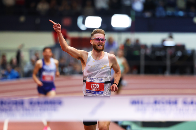 <p>Josh Kerr celebrates as he prepares to clinch the indoor two-mile world record in New York on 11 February </p>