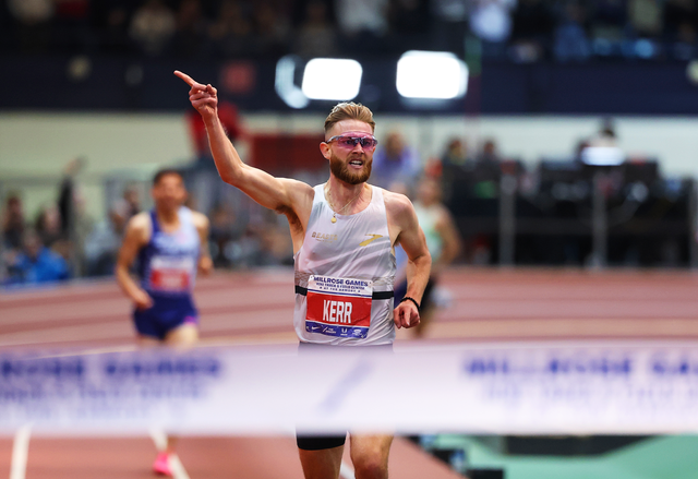<p>Josh Kerr celebrates as he prepares to clinch the indoor two-mile world record in New York on 11 February </p>