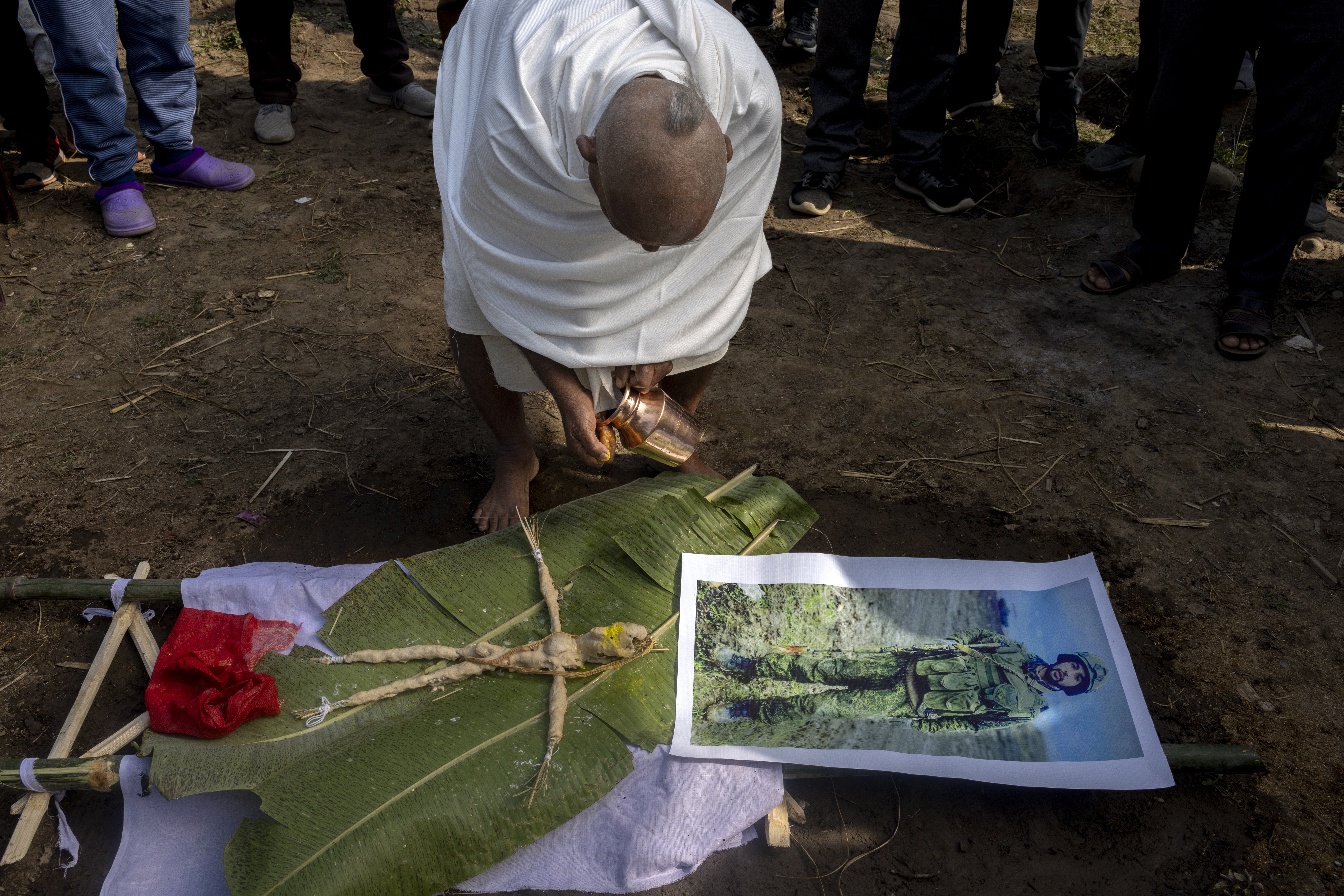 Gangadhar Paudel, an uncle of the deceased Hari Aryal, is dressed in white attire with a shaven head, as he starts Hari’s final rites procession in Walling, Syangja district, Nepal