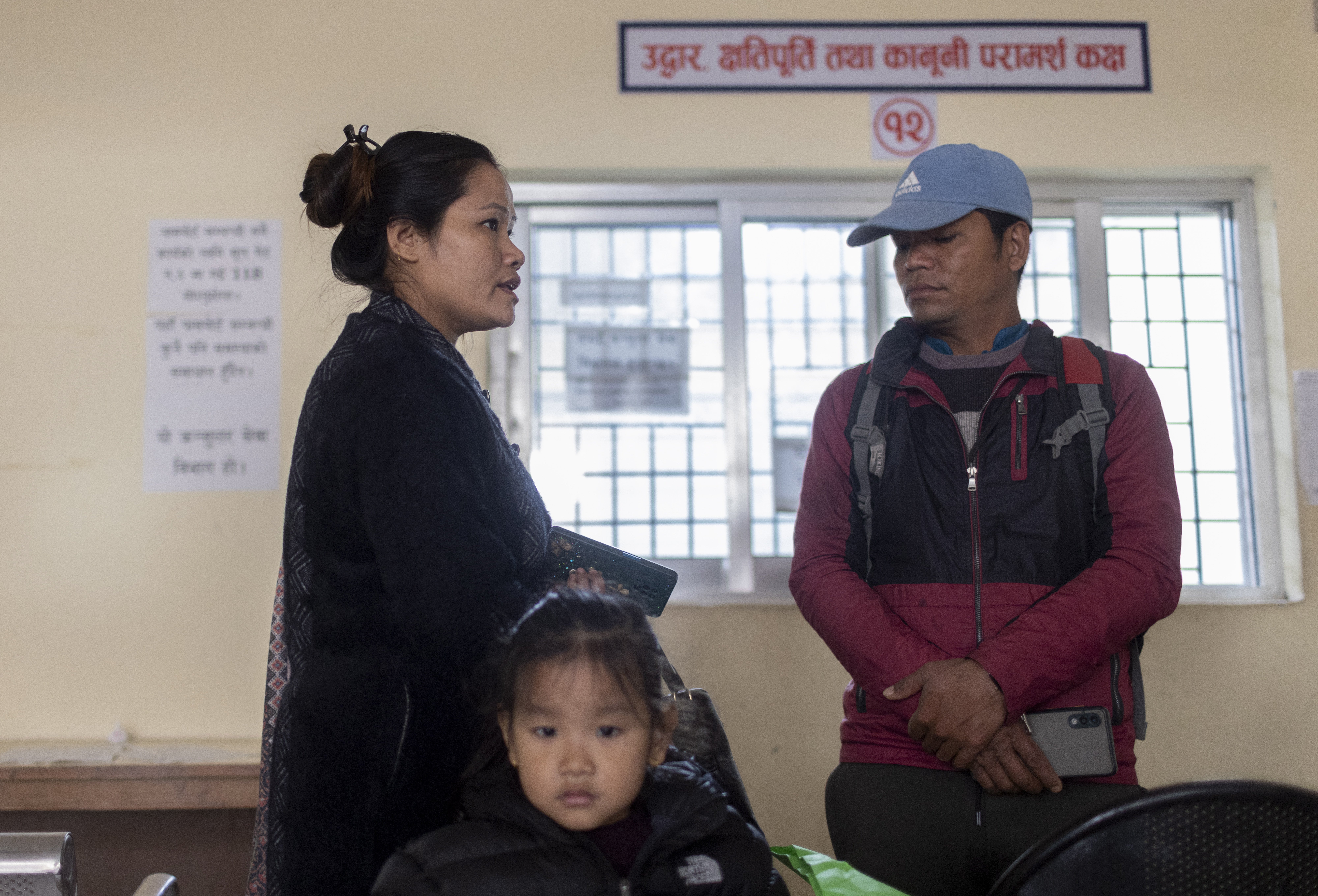 Sanu Kanchi Tumbape (L), along with her brother, submits an appeal letter seeking assistance to rescue her husband, Suresh Tumbape, at the Nepalese Foreign Ministry in Kathmandu