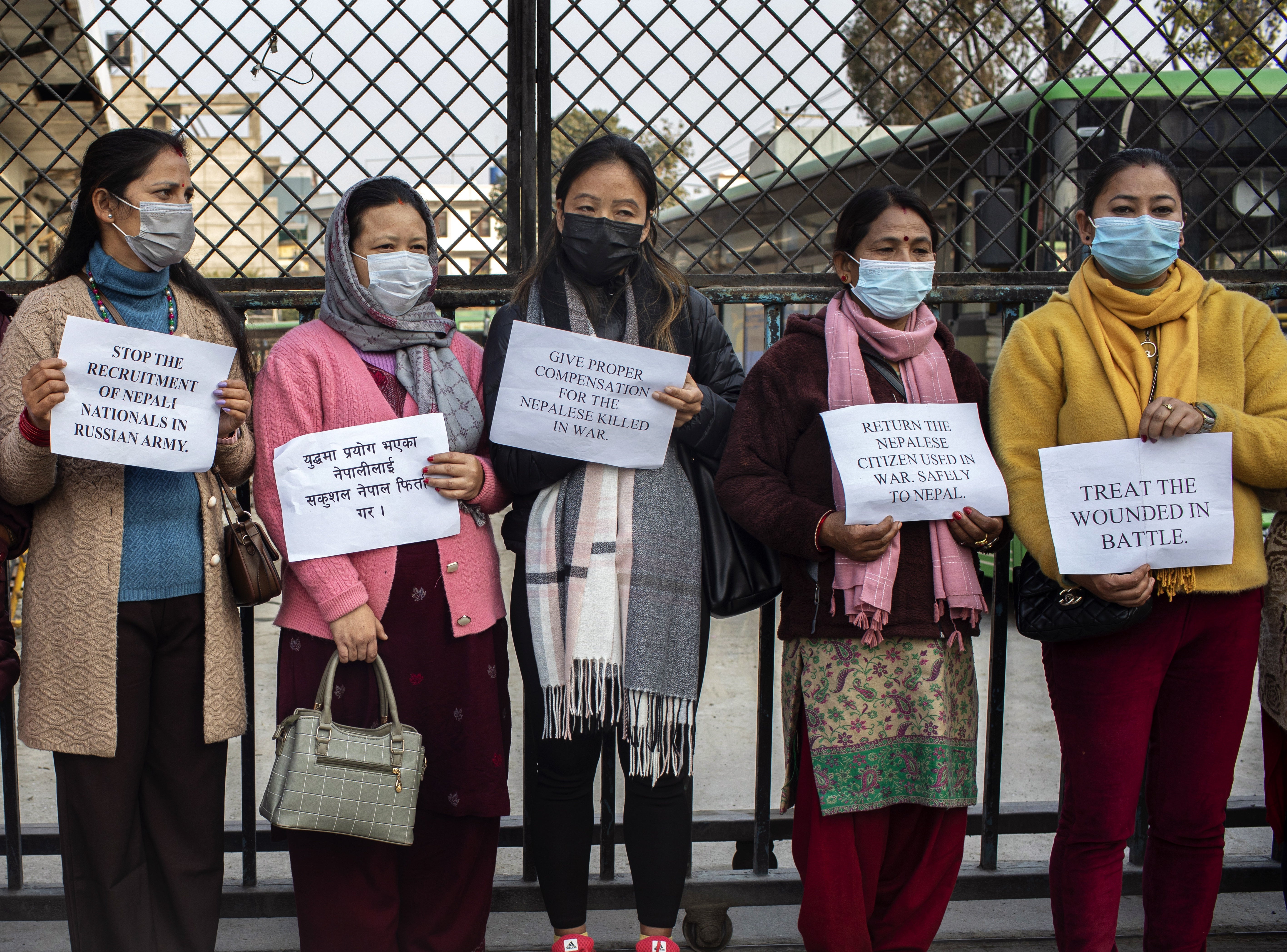 Tina (3-L) and Sita (3-R) at a protest in Kathmandu. Their husbands joined the Russian army four months earlier and are not allowed to return to Nepal before the end of their one-year contract
