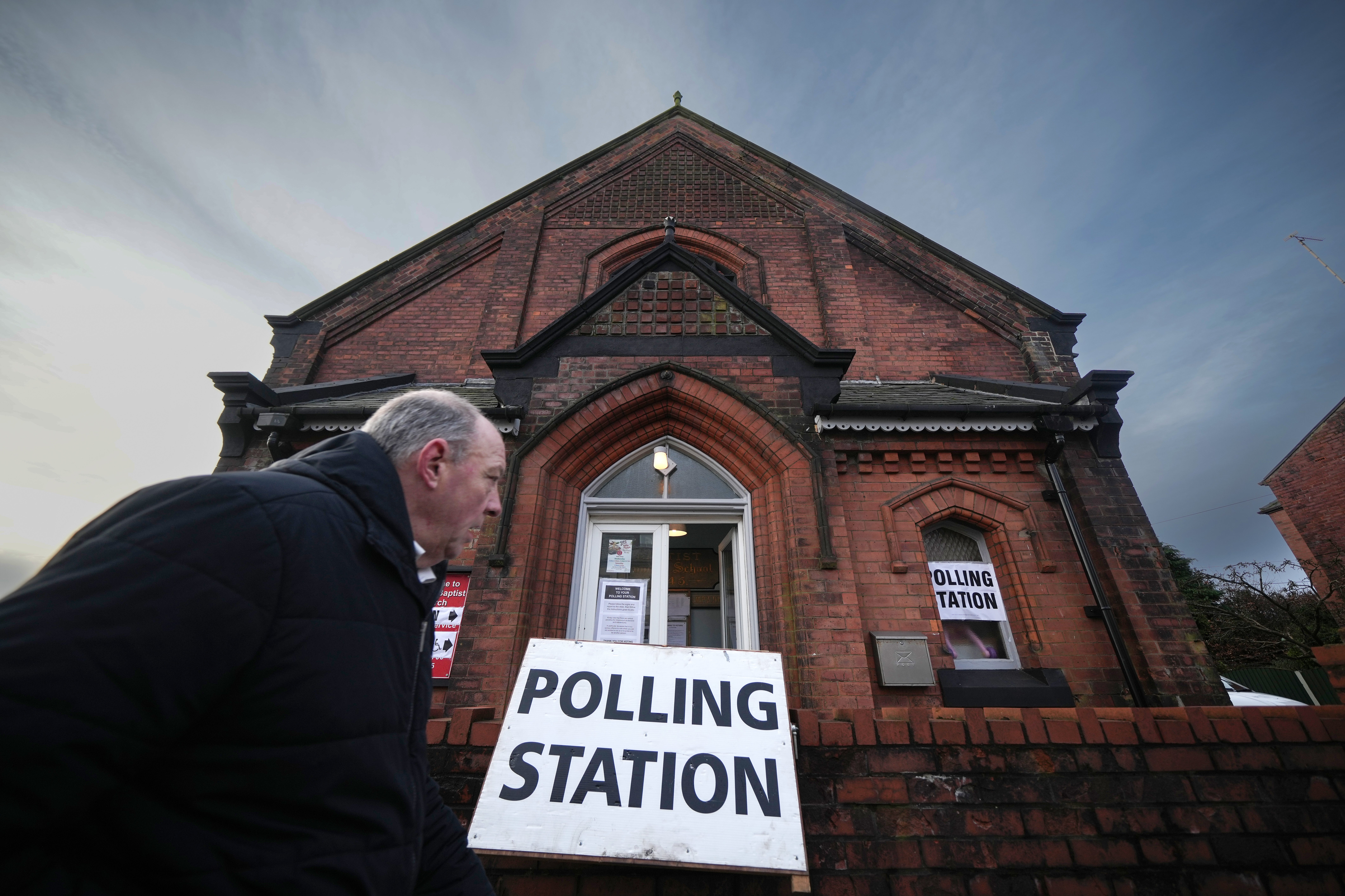 A voter leaves a polling station after voting in the Rochdale by-election on February 29