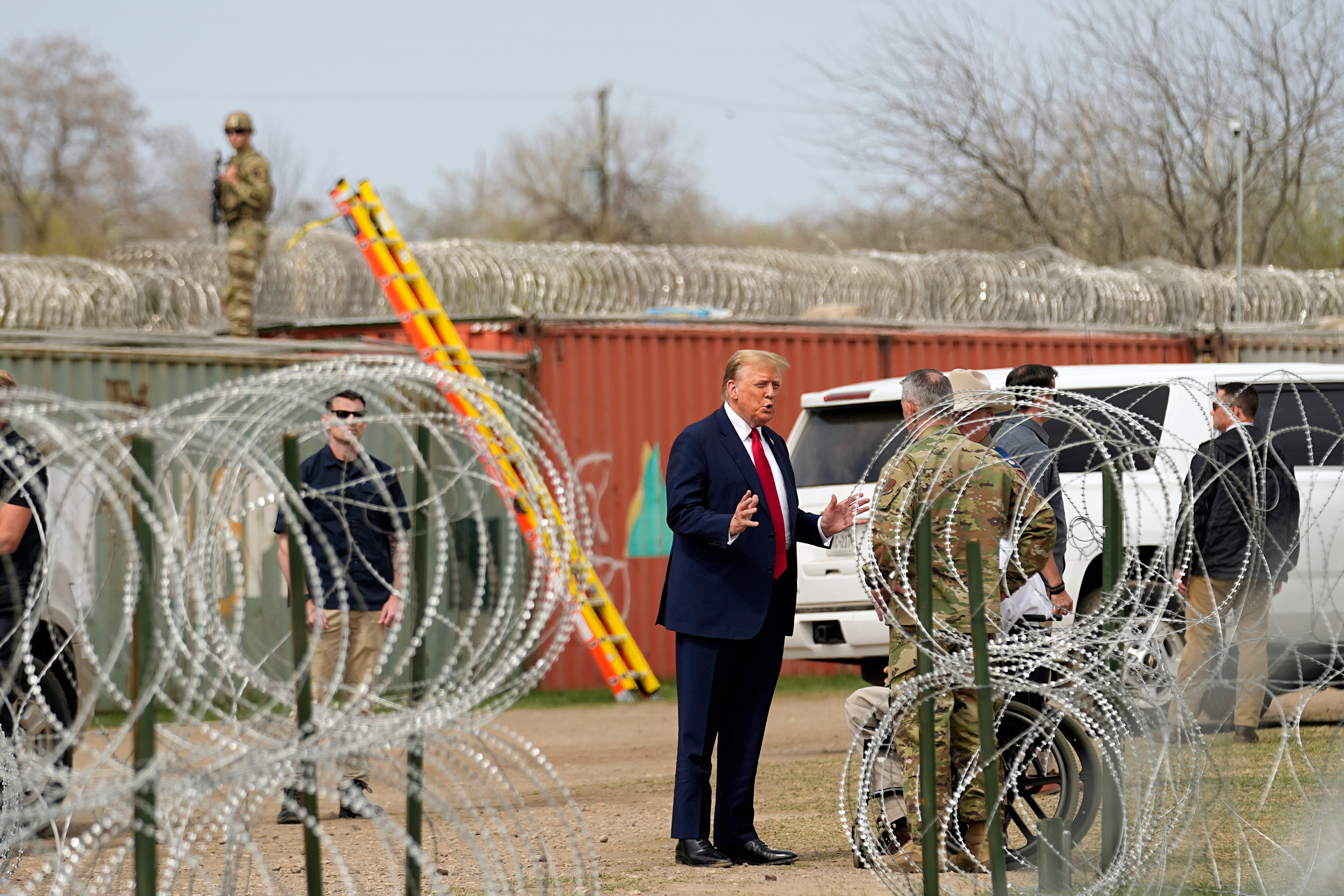 Mr Trump surrounded by razor wire