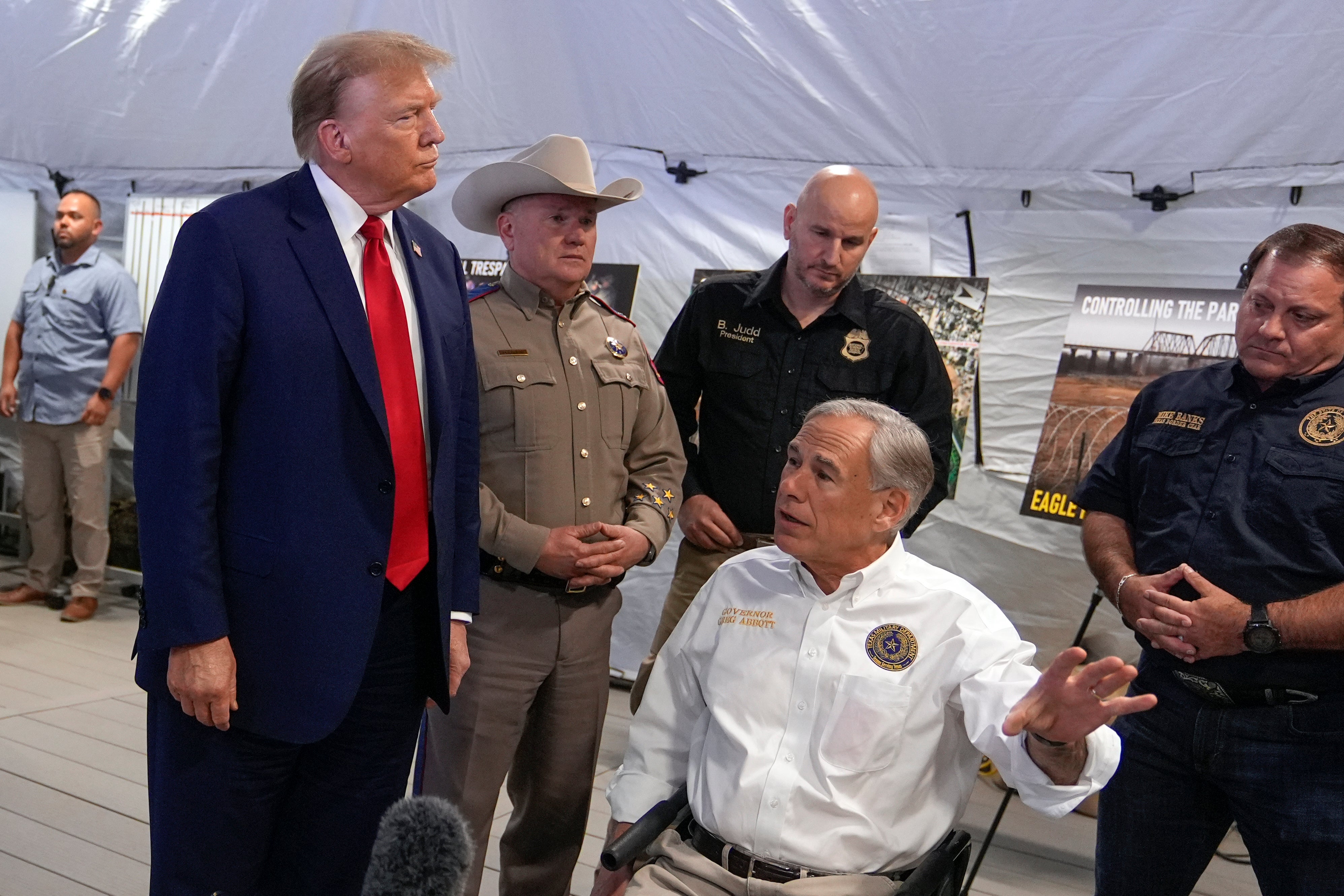 Mr Trump was met in Eagle Pass by Texas Governor Greg Abbott (right)