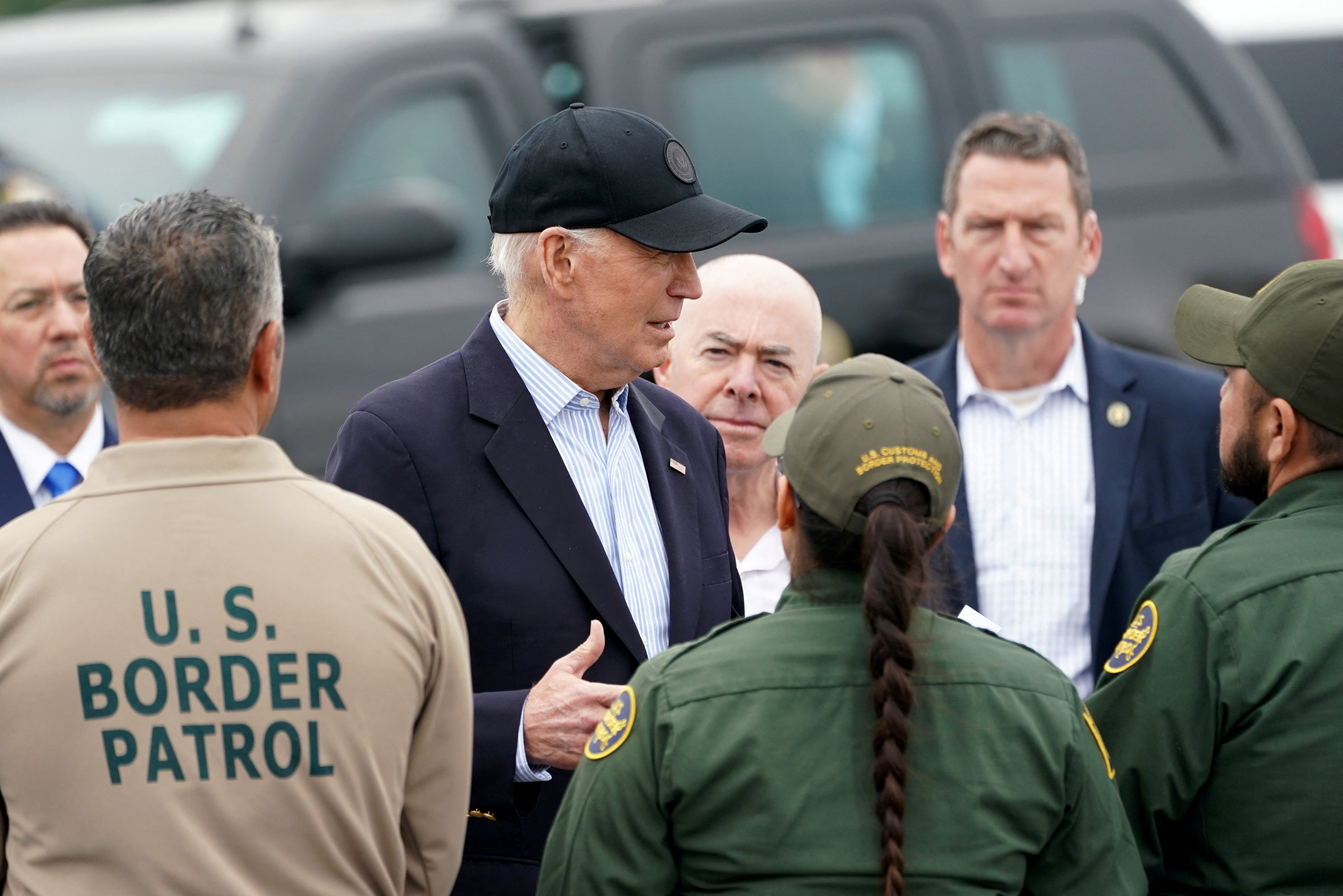Joe Biden, flanked by US Homeland Security Secretary Alejandro Mayorkas, receives a briefing at the US-Mexico border in Brownsville, Texas