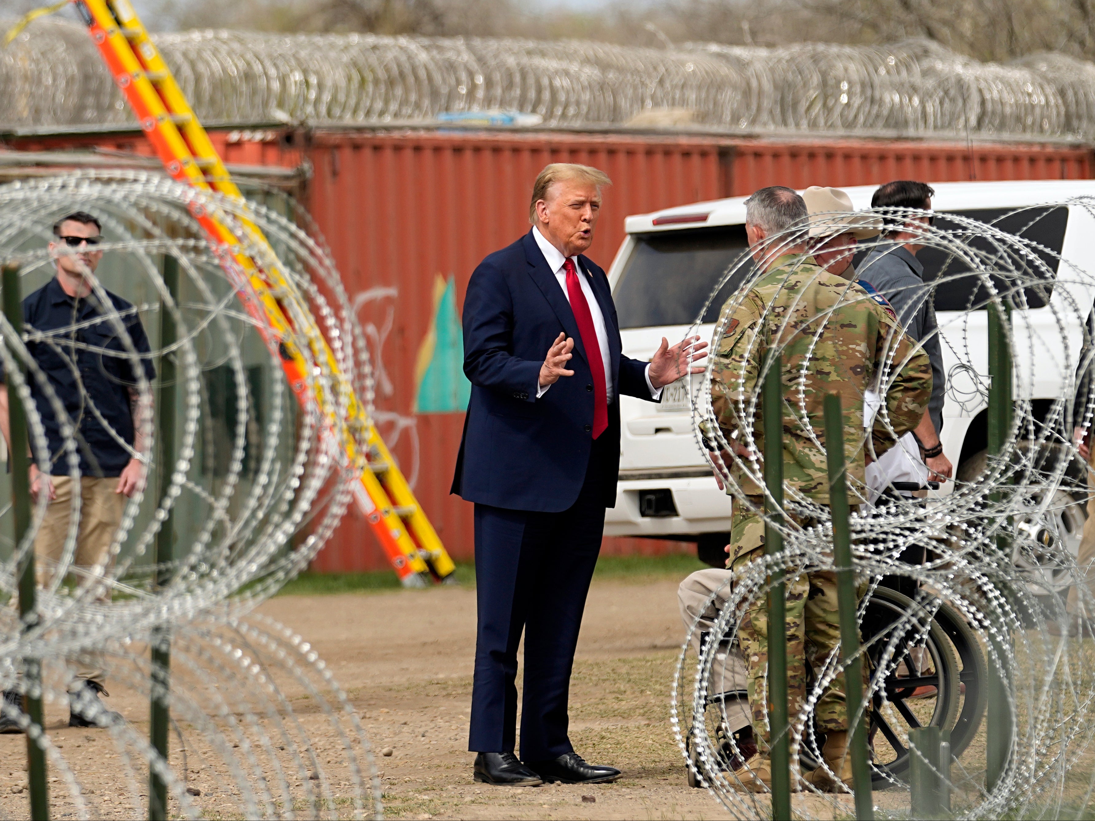 <p>Donald Trump speaks as he arrives for a visit to the US-Mexico border on 29 February 2024</p>