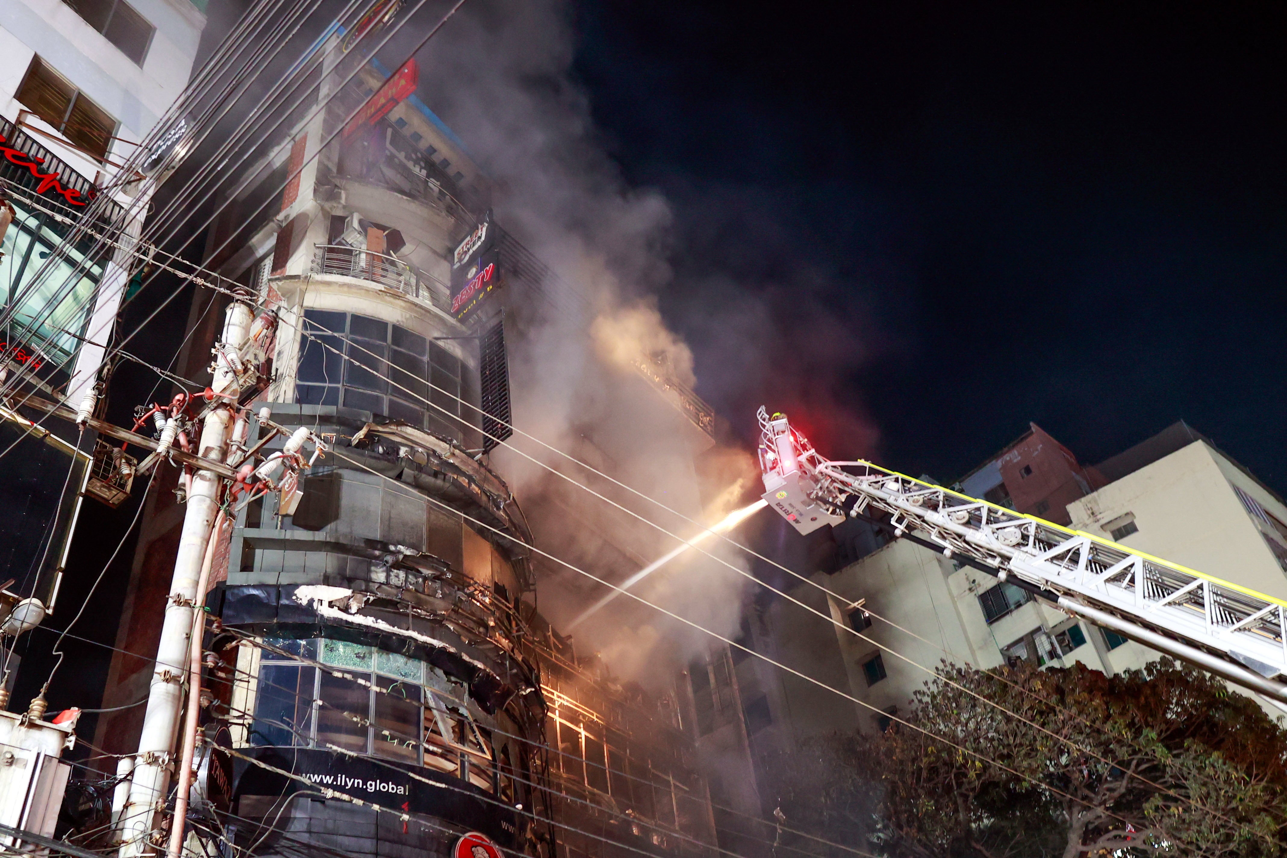 <p>Bangladeshi firefighters try to douse the fire after flames erupted at a building in Dhaka, Bangladesh, late 29 February 2024</p>