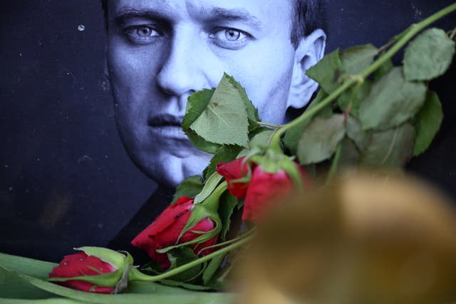 <p>Roses are laid at a picture of late Russian opposition leader Alexei Navalny at a makeshift memorial</p>