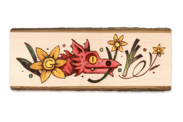The doodle depicts a Welsh red dragon holding a daffodil and includes a leek