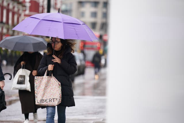 <p>People walk in the rain in central London on Friday 1 March </p>