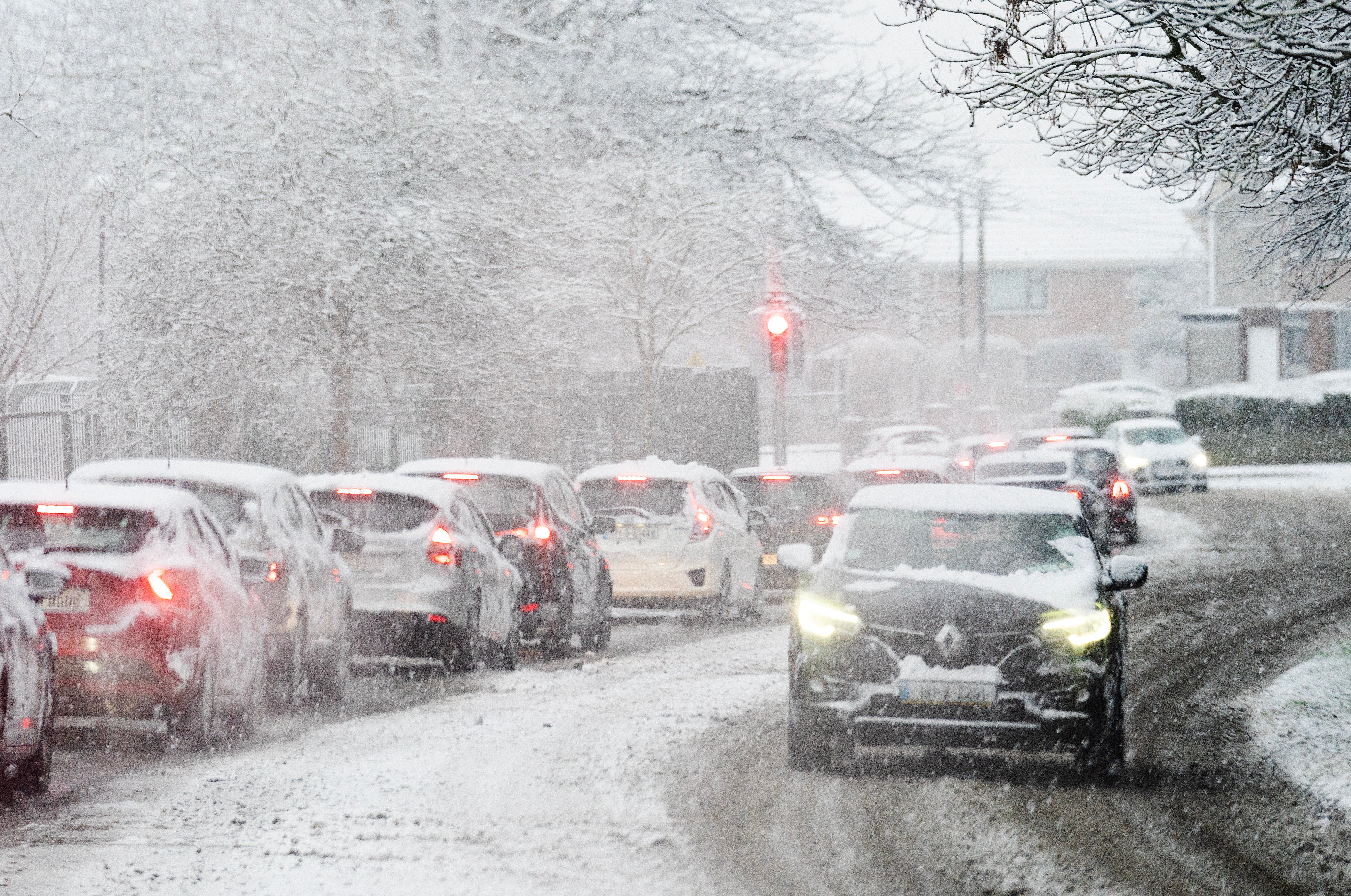 Traffic Ballygall road as snow falls on the Northside of Dublin