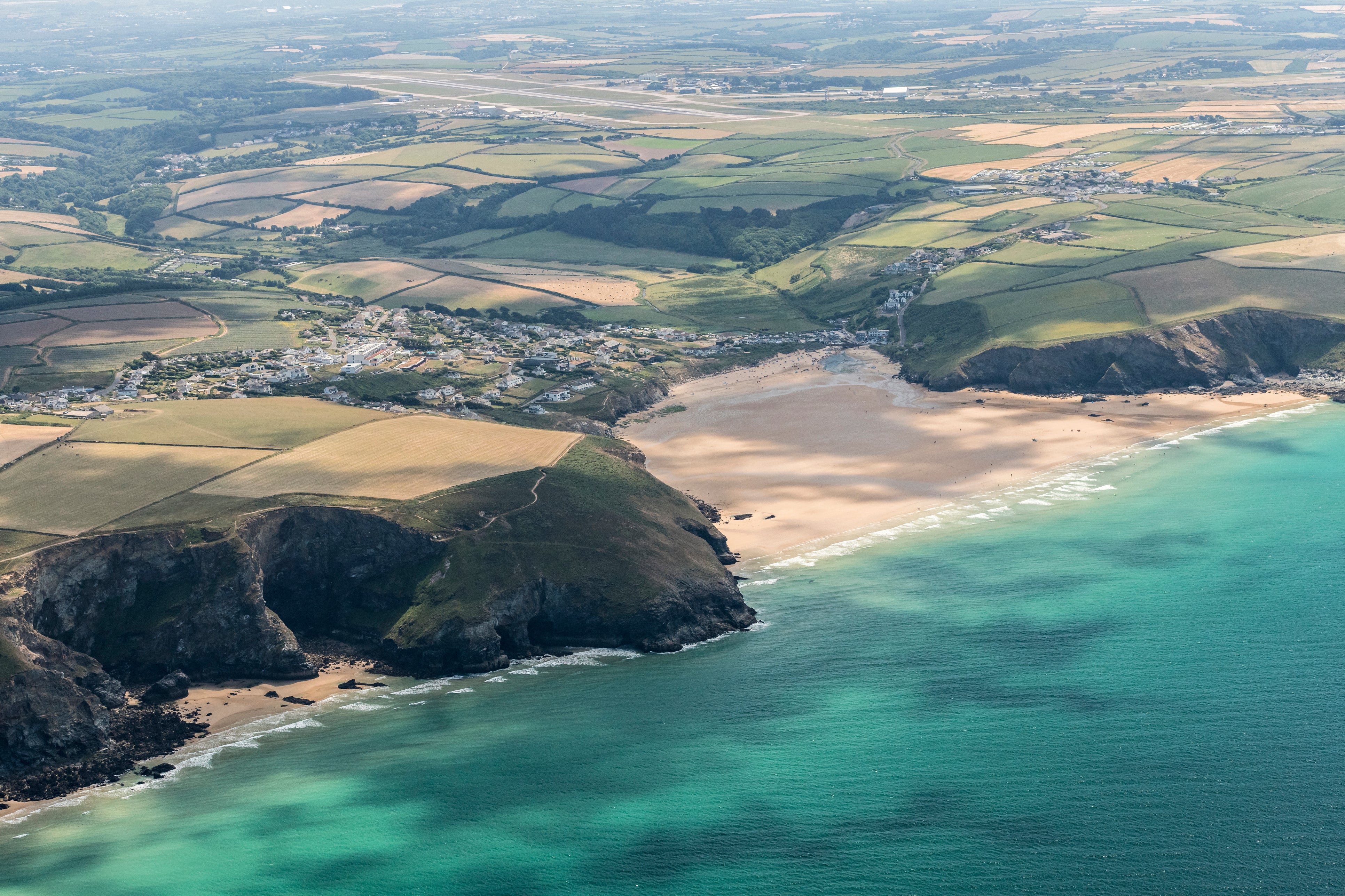 Aerial Views over Mawgan Porth Beach, Cornwall on a sunny June day