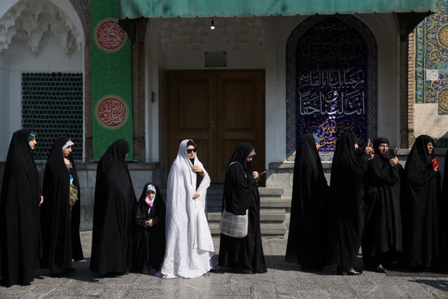 <p>Iranians wait in line to vote at a polling station during parliamentary elections in Tehran</p>