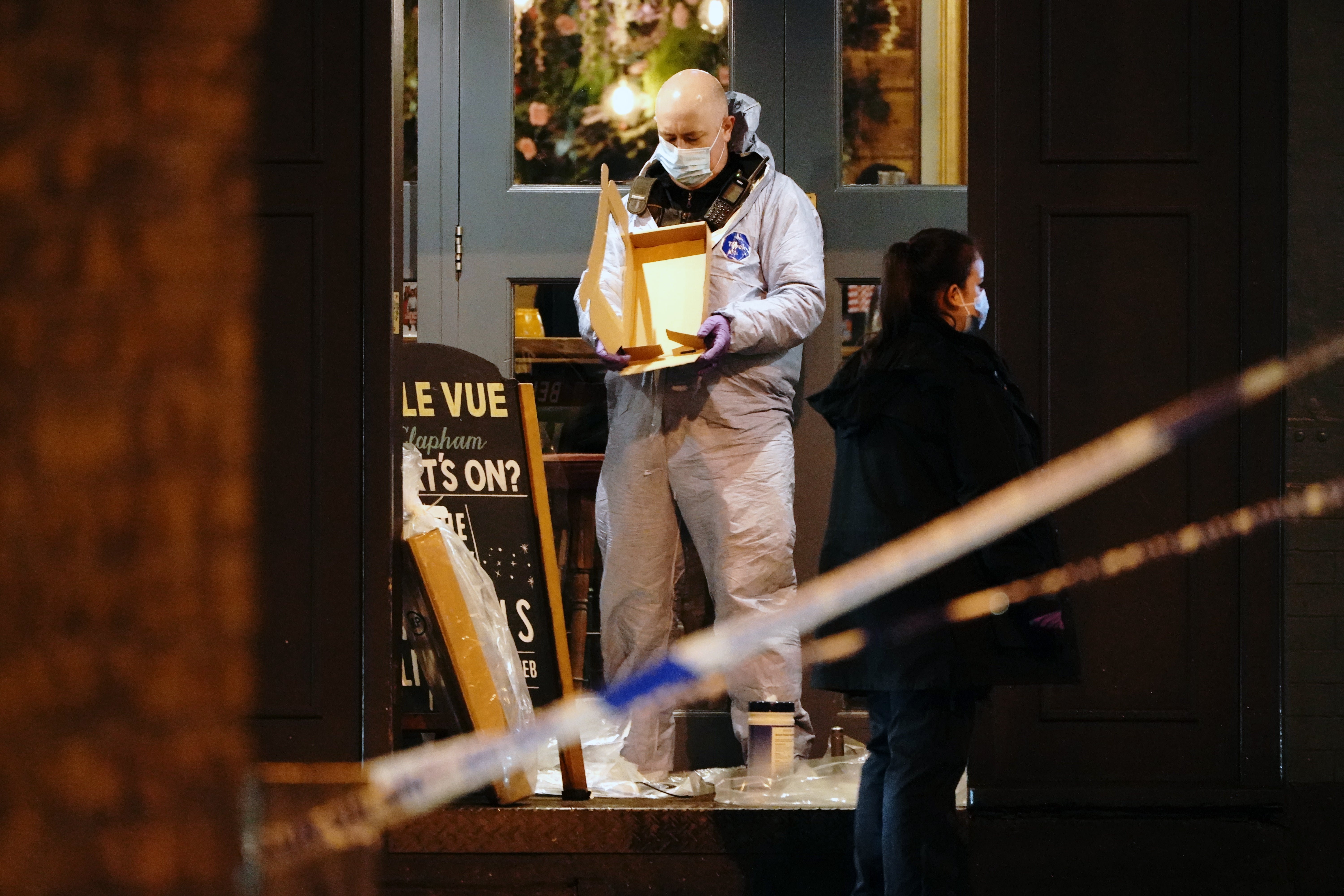 A forensic officer at the scene of a shooting in Clapham