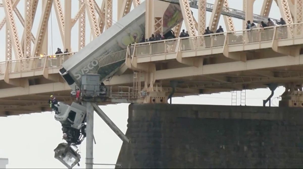 Rescue of truck driver dangling from bridge was a team effort, firefighter says