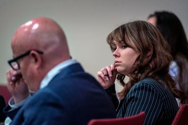 <p>Hannah Gutierrez-Reed, center, sits with her attorney Jason Bowles, left, during testimony in the trial against her in First District Court, in Santa Fe, New Mexico on 1 March 2024</p>
