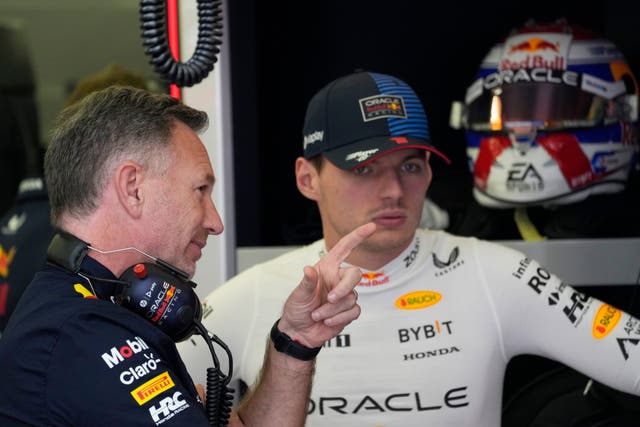 Christian Horner, left, speaks with Max Verstappen in Bahrain (Darko Bandic/AP)