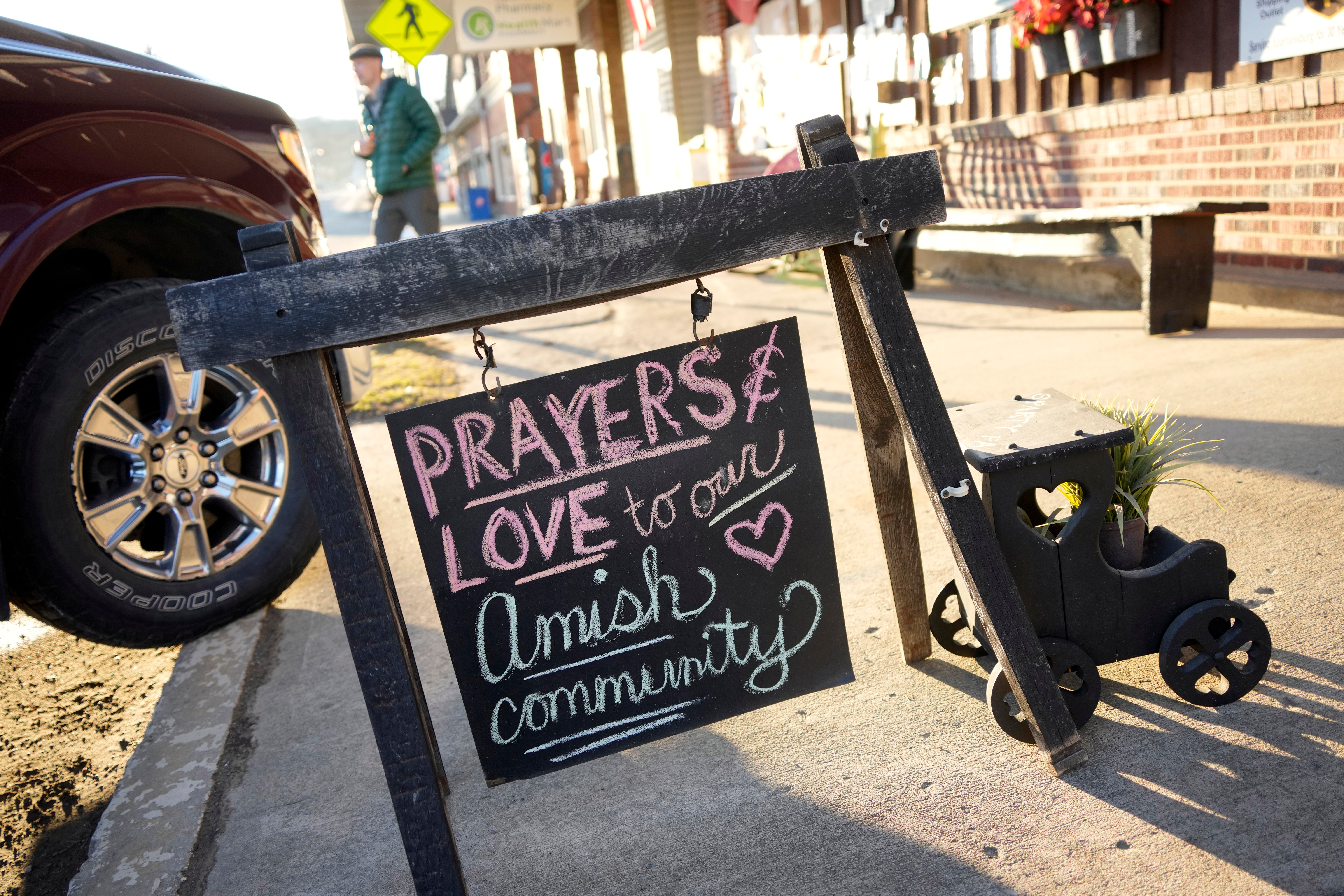 A sign on the sidewalk outside an antique store in Spartan pays tribute to the slain woman