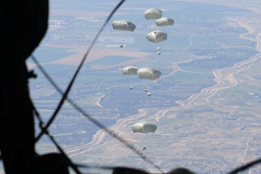 Jordanian Armed Forces members airdrop aid parcels to several areas in northern Gaza