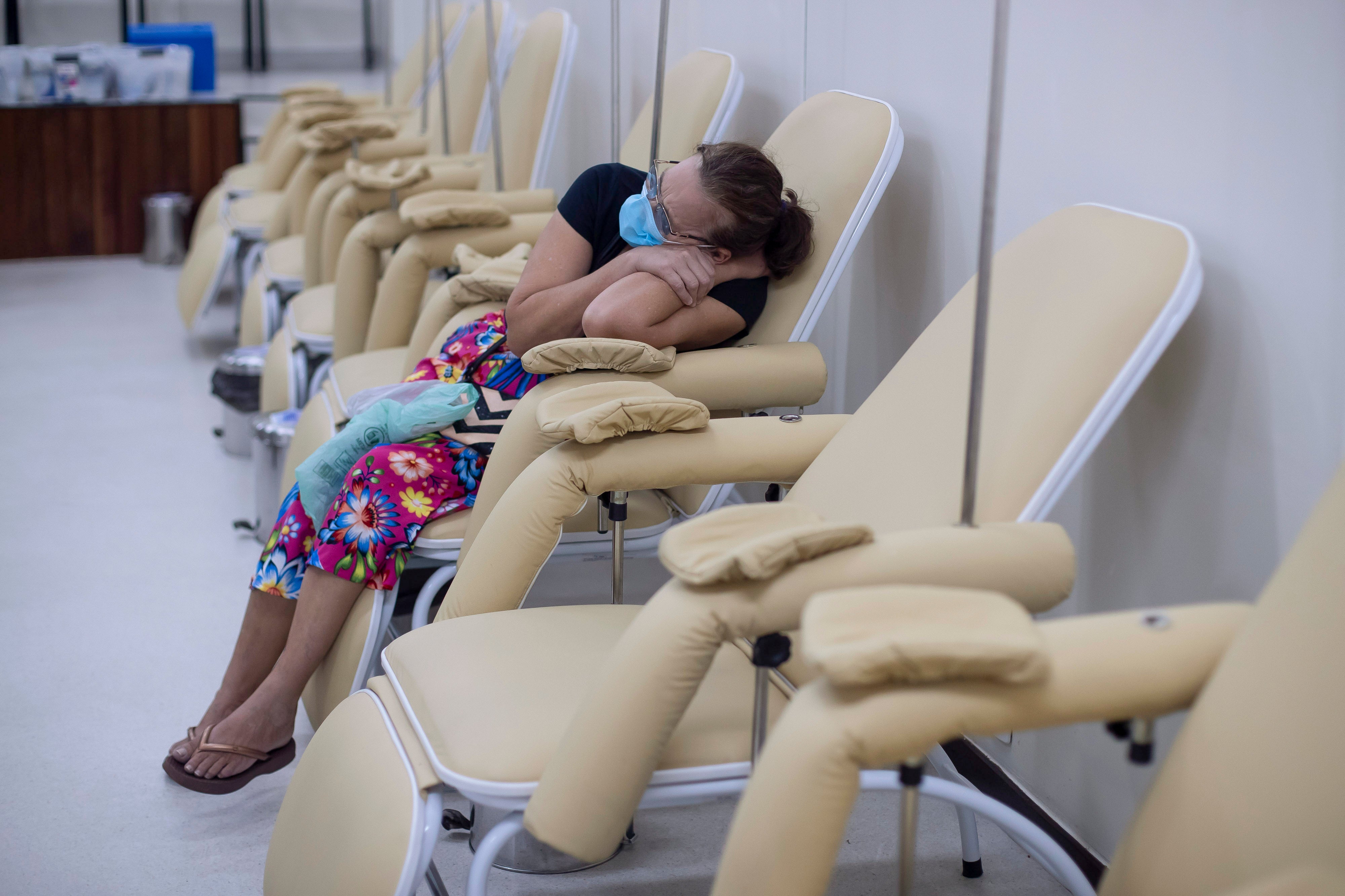 A woman suspected of having dengue fever waits for medical attention at the Rodolpho Rocco Municipal Polyclinic in Rio de Janeiro