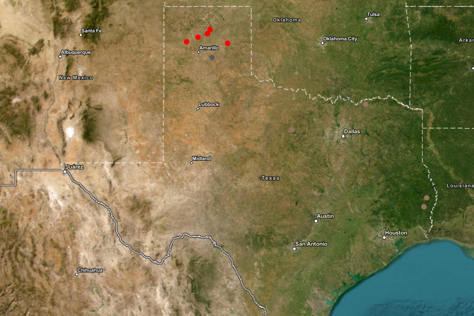 A map of Texas with red dots representing active fires, grey dots representing controlled fires and brown dots representing contained fires