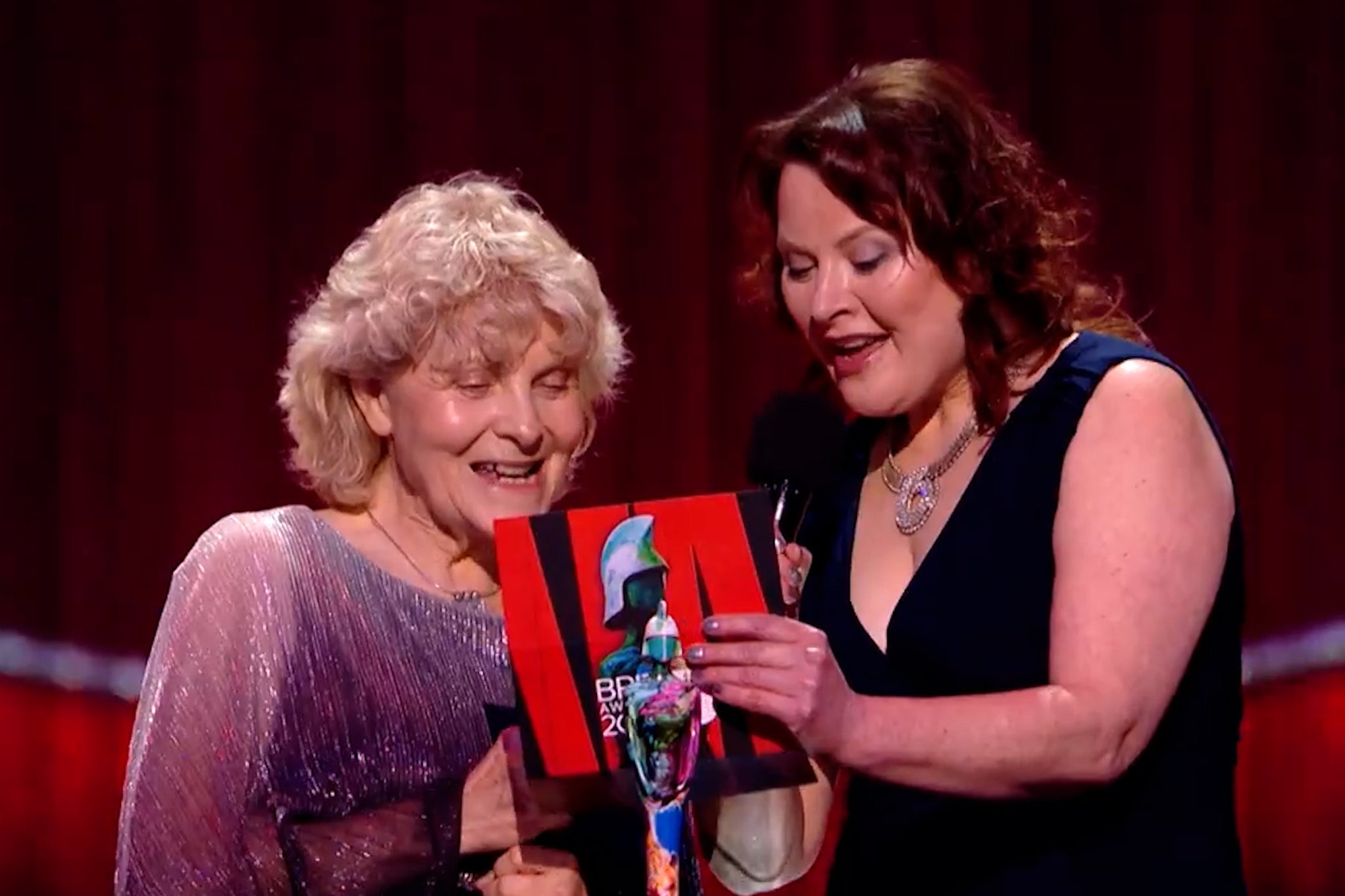 Jo Hamilton, left, helping to present a Brit Award to Raye