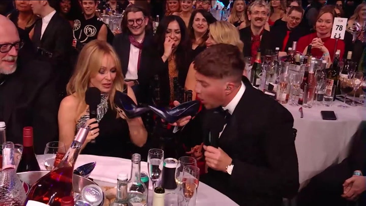 Roman Kemp and Kylie Minogue drink out of shoes together at Brit Awards 2024 thumbnail
