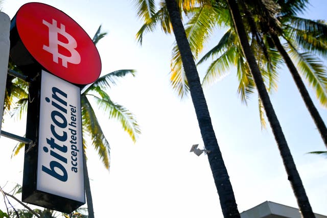 <p>A sign promoting bitcoin transactions is seen outside a hotel in El Zonte beach, El Salvador, on 27 August, 2022</p>