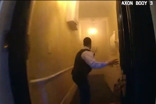 <p>Metropolitan Police officers kicking down a front door to rescue people from a burning building in Emperor's Gate, South Kensington</p>