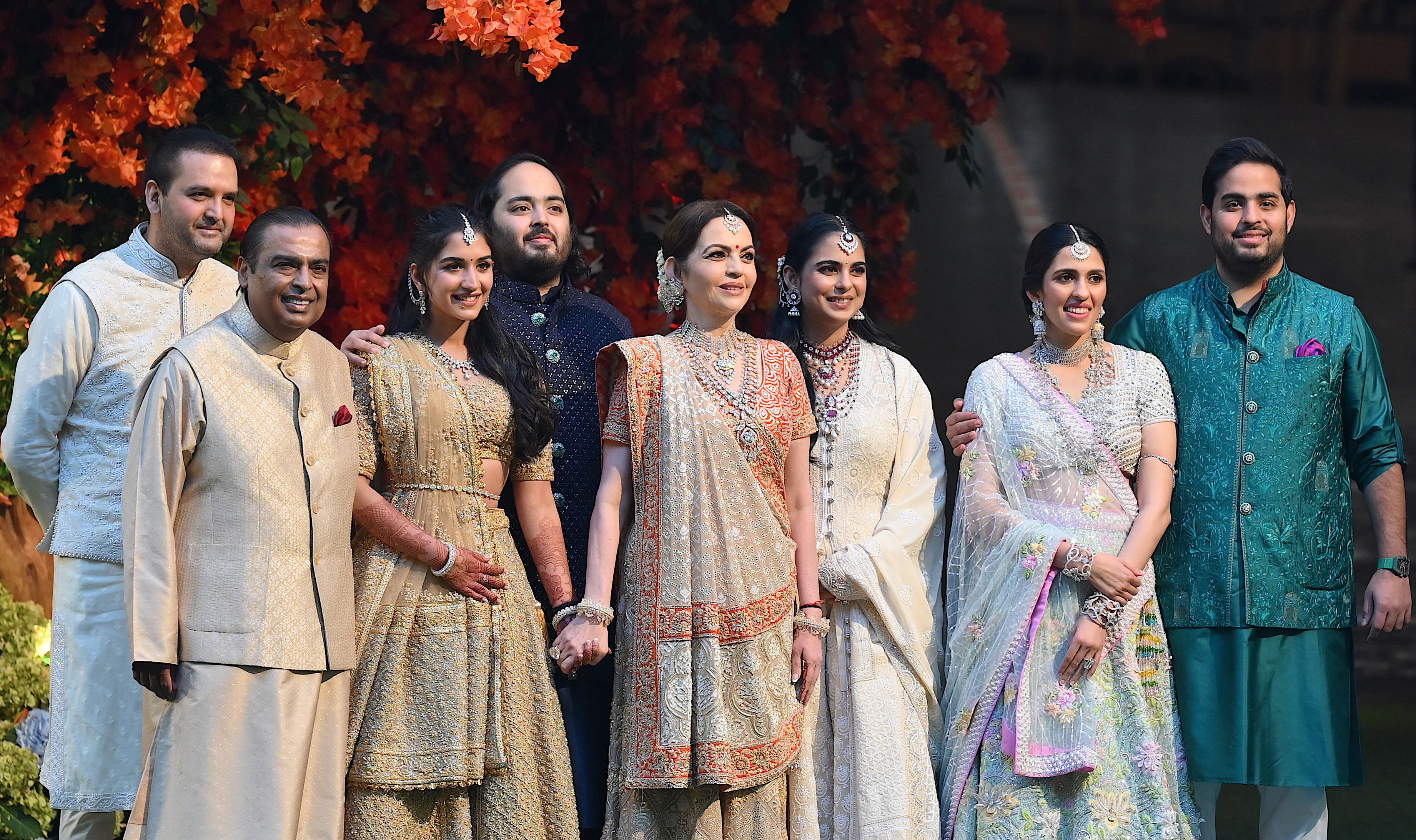 <p>Indian billionaire Mukesh Ambani (2L) along with his wife Nita (4R) pose with their elder son Akash (R) his wife Shloka (2R), daughter Isha (3R) her husband Anand Piramal (L) and younger son Anant (4L) his fiancÃ©e Radhika Merchant (3L) during Anant’s engagement ceremony in Mumbai on 19 January 2023</p>