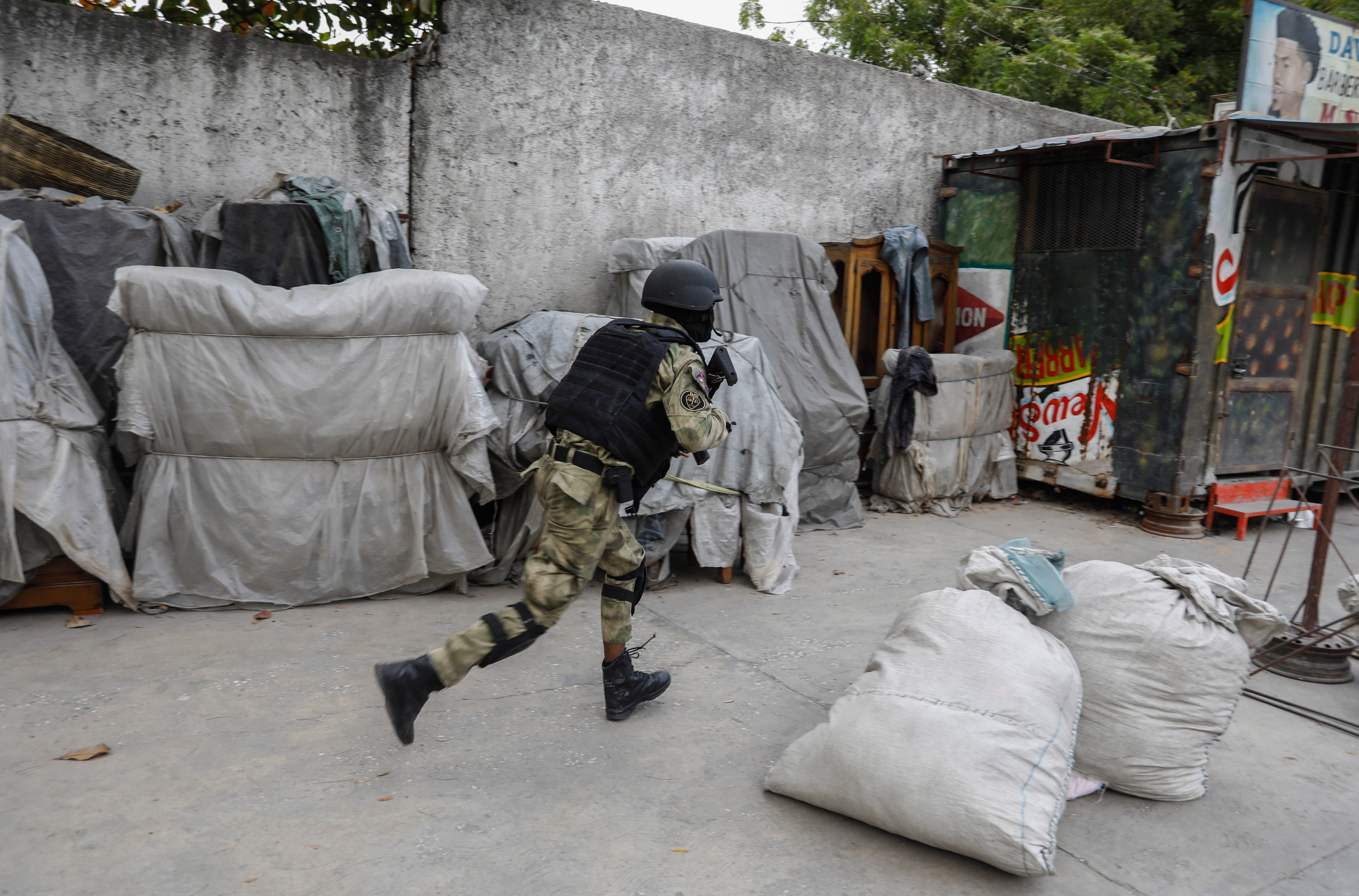 A police officer takes part in an anti-gang operation in the Portail neighbourhood of Port-au-Prince