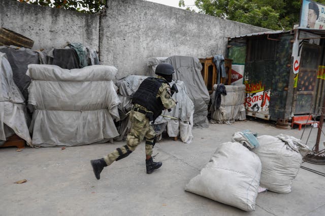 <p>A police officer runs during an anti-gang operation at the Portail neighborhood of Port-au-Prince, Haiti</p>