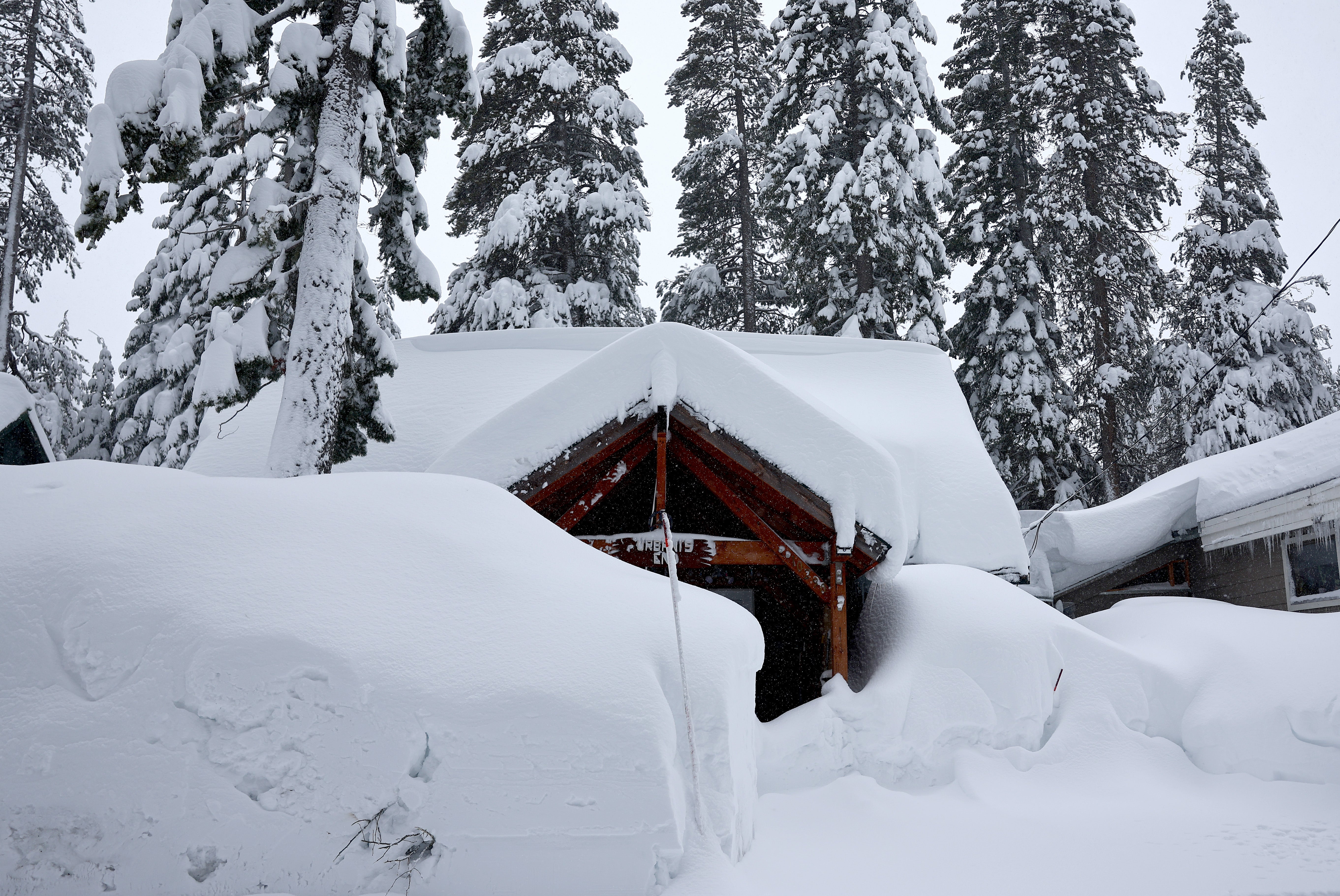 Homes are covered in snow during a powerful multiple day winter storm in the Sierra Nevada mountains, which is boosting the snowpack, on March 03, 2024 in Truckee, California