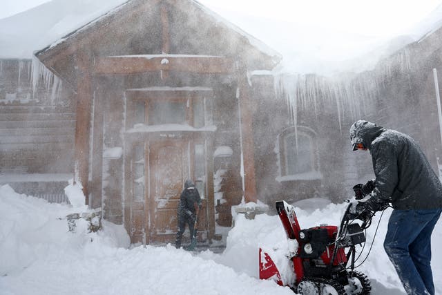 <p>Residents clear out snow in front of their home on Donner Pass Road during a powerful multiple day winter storm in the Sierra Nevada mountains</p>