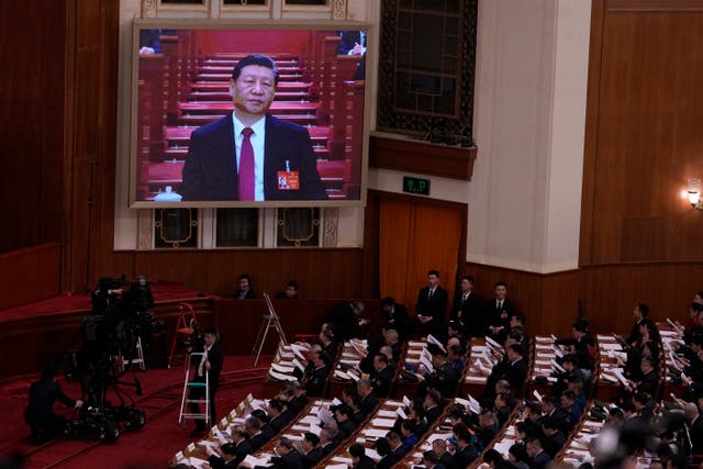<p>Chinese President Xi Jinping, on screen, listens to the opening remark by Chinese Premier Li Qiang </p>