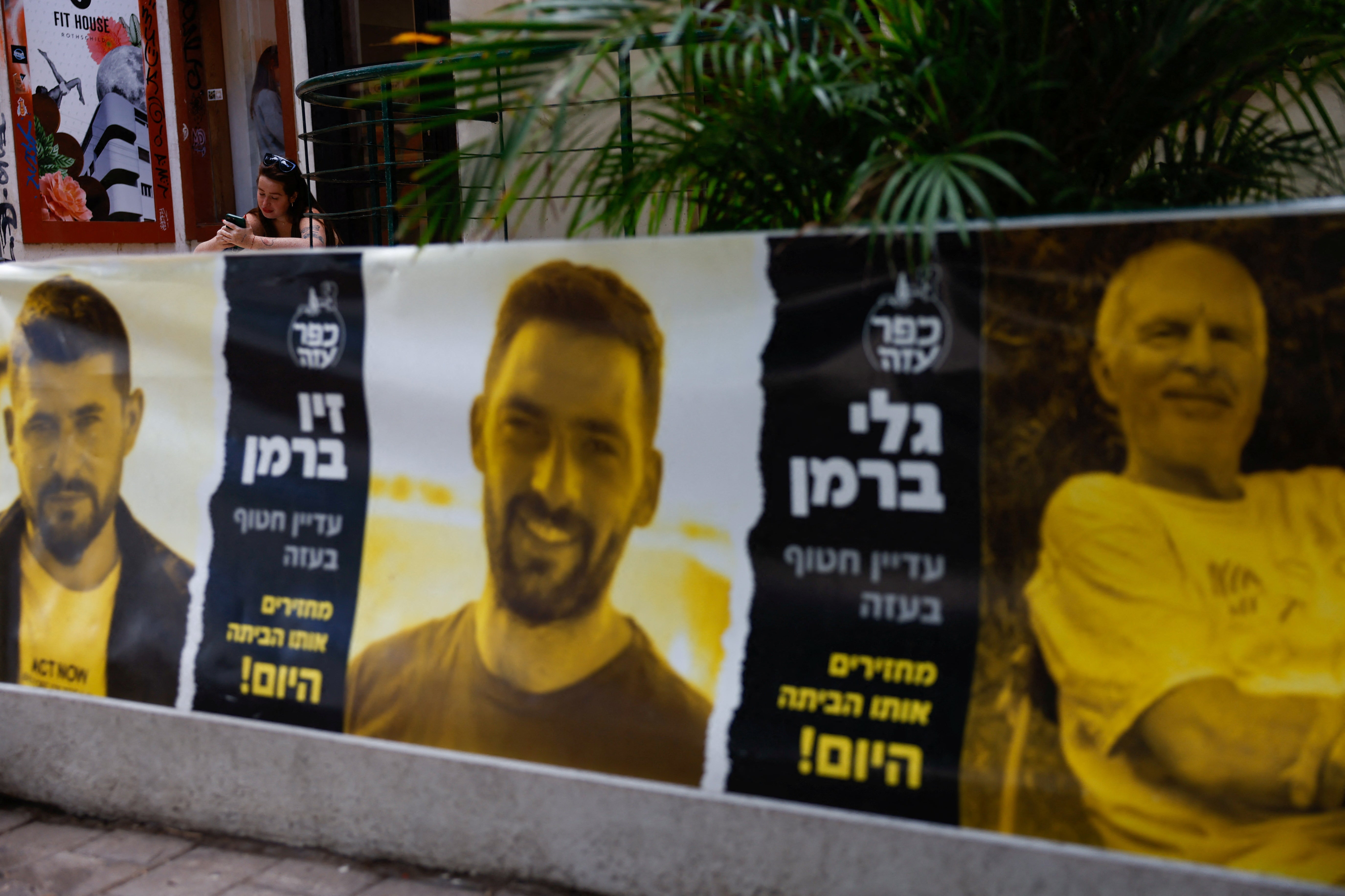 A banner in Tel Aviv displays photos of hostages kidnapped in the deadly 7 October attack