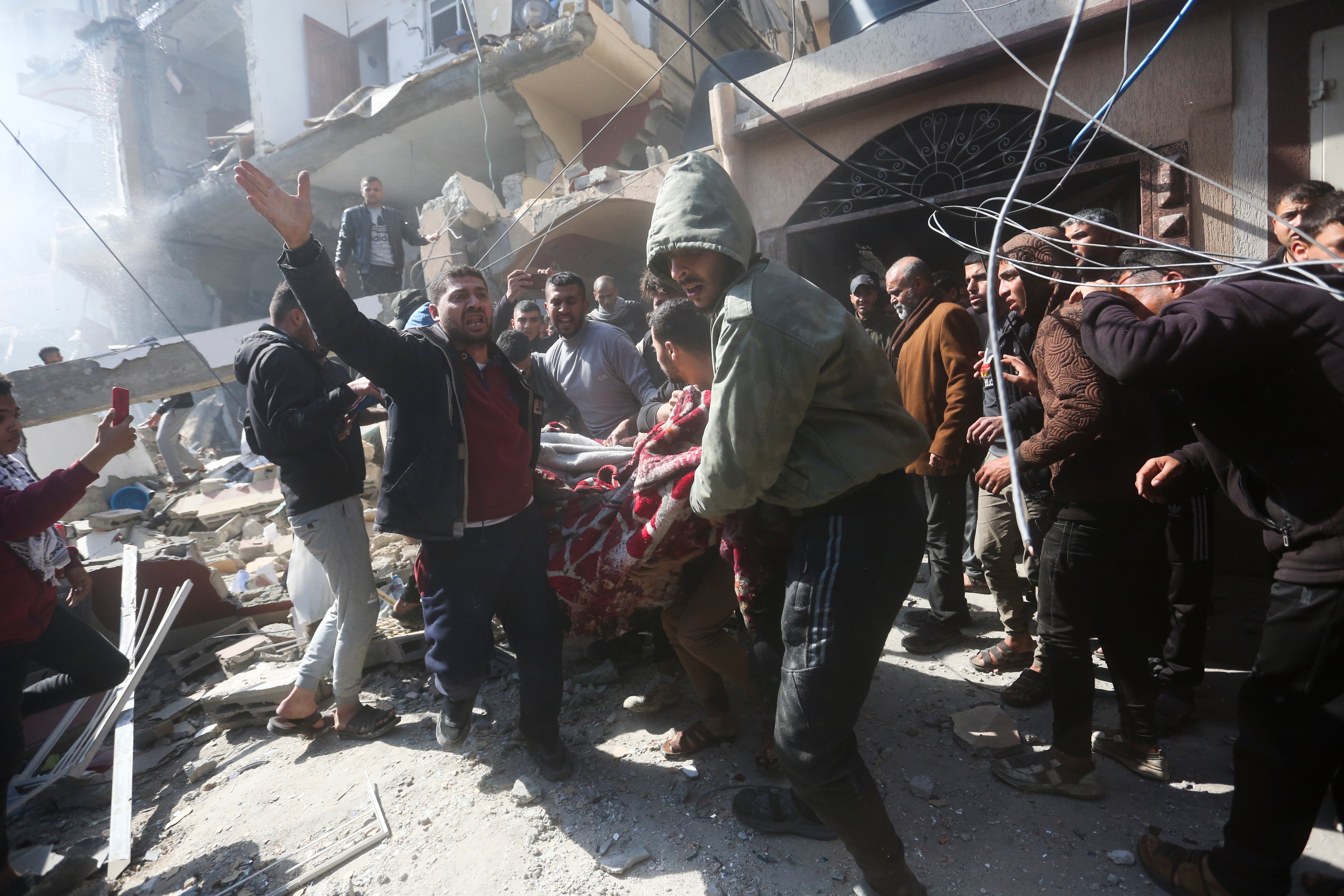 Palestinians rescue survivors after an Israeli strike on Shaheen family house in Rafah, Gaza Strip, Saturday, 24 February 2024