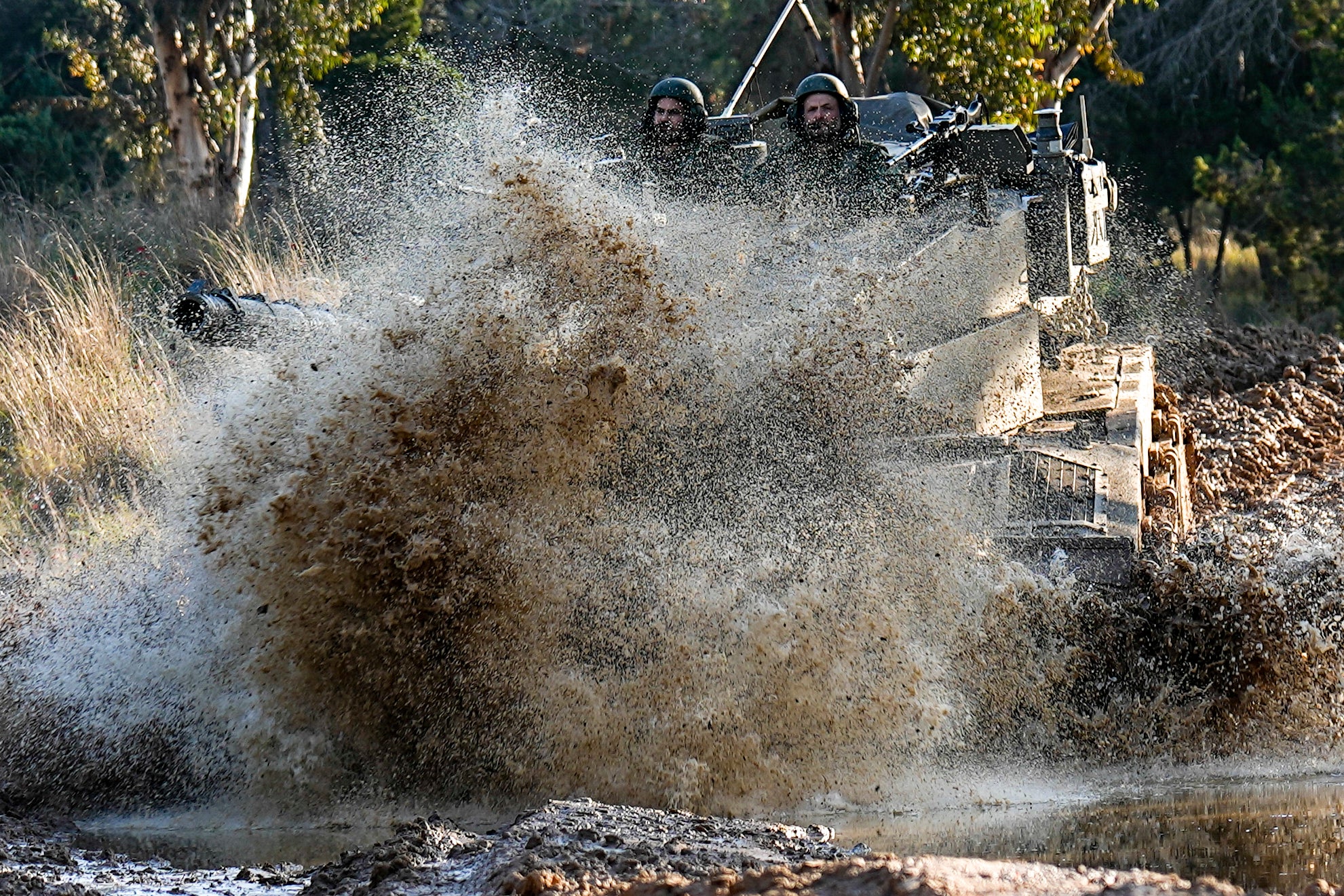 <p>Israeli soldiers drive a tank on the border with the Gaza Strip, as seen from southern Israel</p>