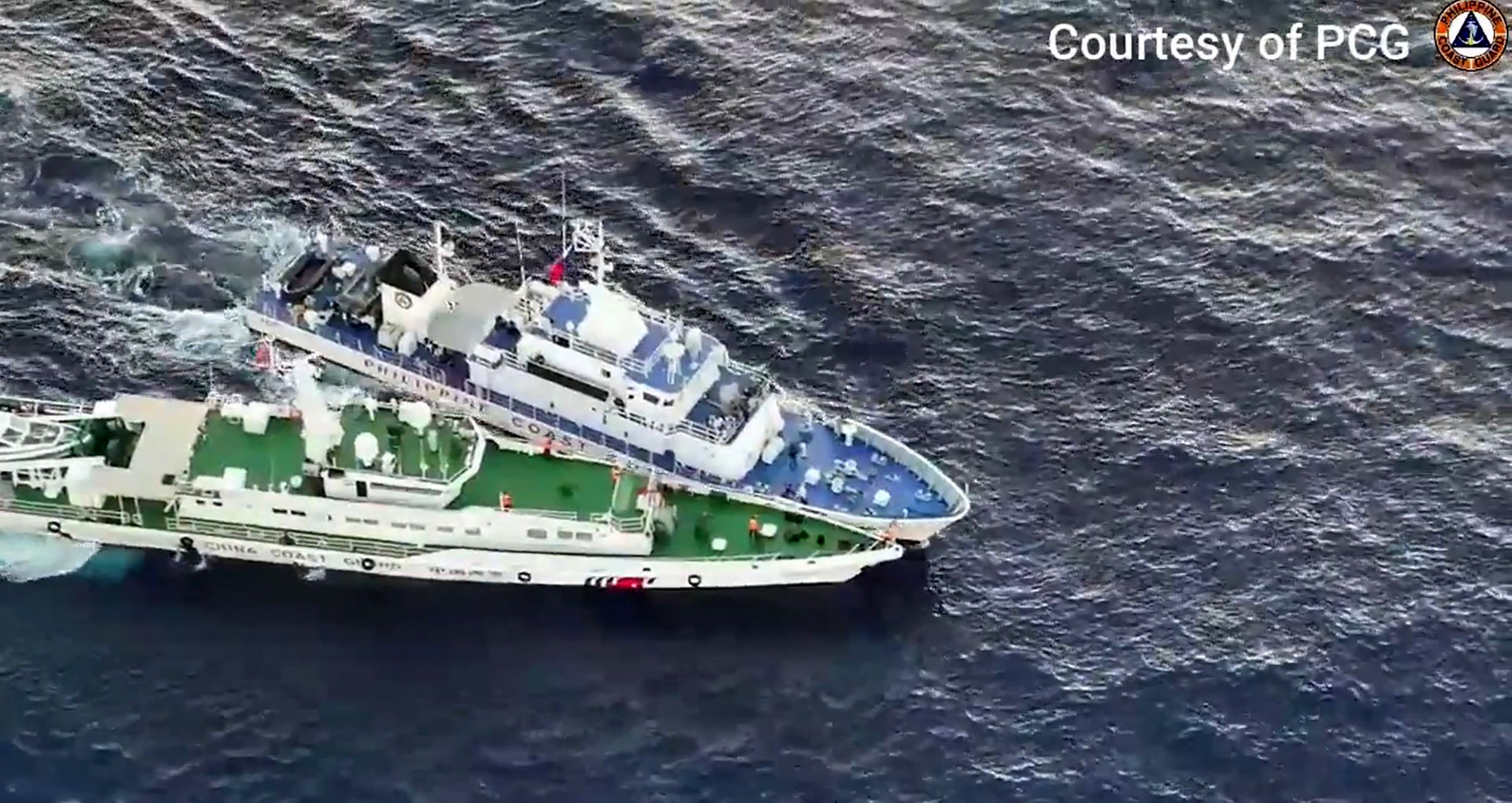 <p>In this frame grab from aerial video footage taken on 5 March 2024 and released by the Philippine Coast Guard (PCG), a Chinese Coast Guard ship (bottom) and a Philippine coast guard ship are seen during a collision during a supply mission near Second Thomas Shoal in the disputed South China Sea</p>