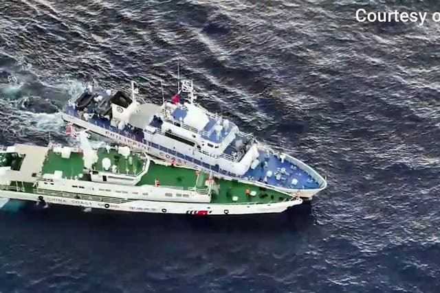 <p>In this frame grab from aerial video footage taken on 5 March 2024 and released by the Philippine Coast Guard (PCG), a Chinese Coast Guard ship (bottom) and a Philippine coast guard ship are seen during a collision during a supply mission near Second Thomas Shoal in the disputed South China Sea</p>