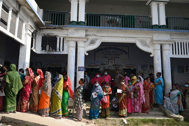 <p>Voters stand in a line to cast their vote outside a polling station in West Bengal, India</p>