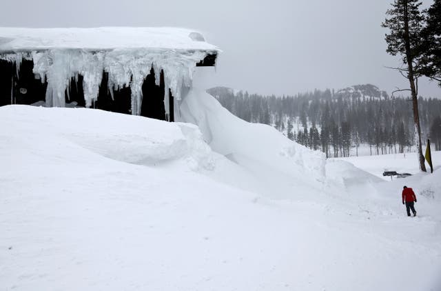 <p>A person walks at Boreal Mountain Resort, currently shuttered due to the snowstorm, following a massive snowstorm in the Sierra Nevada mountains on March 04, 2024 at Soda Springs, California</p>