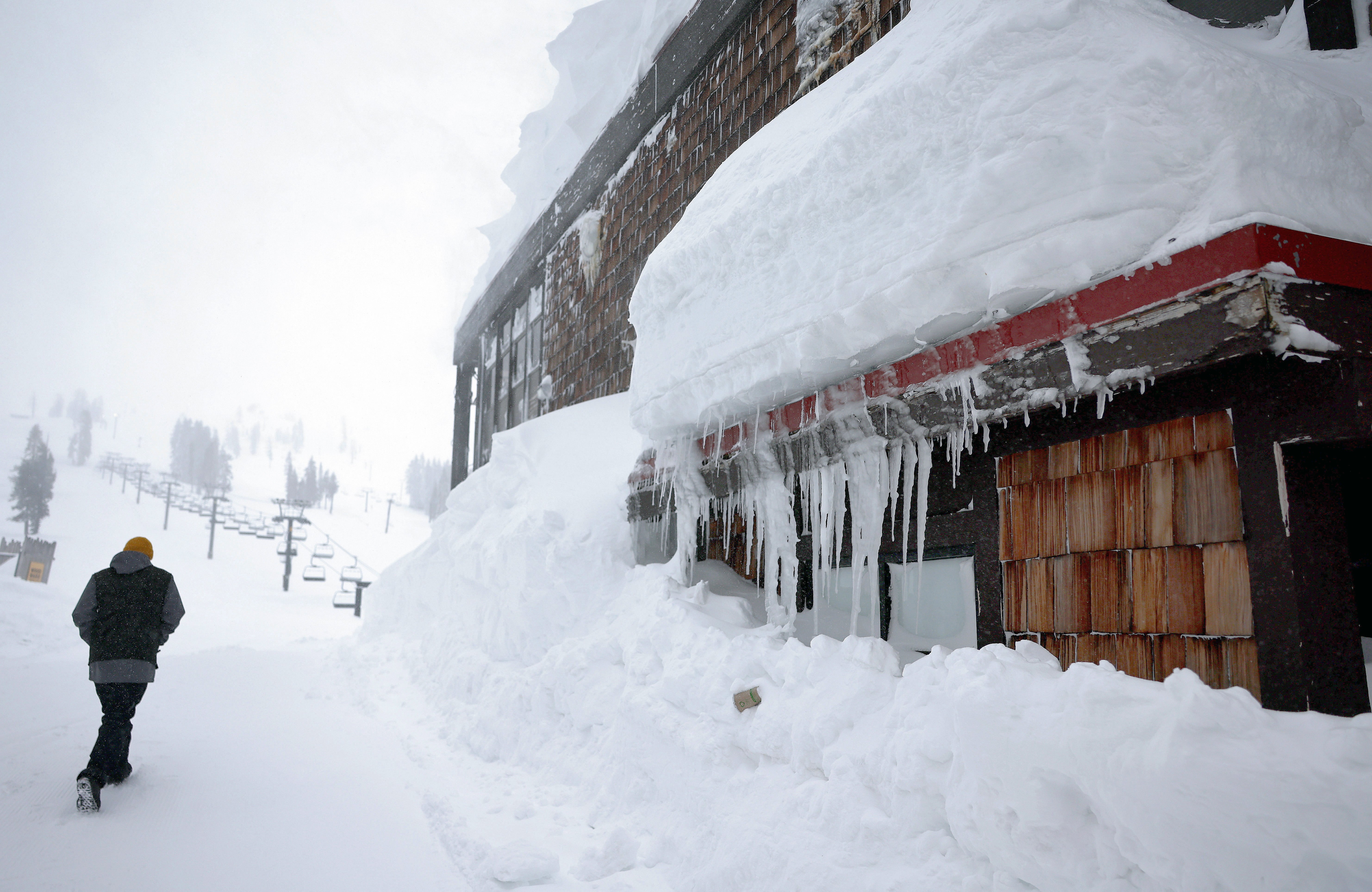 A person walks at Boreal Mountain Resort, currently shuttered due to the snowstorm, following a massive snowstorm in the Sierra Nevada mountains on March 04, 2024 in Soda Springs, California.