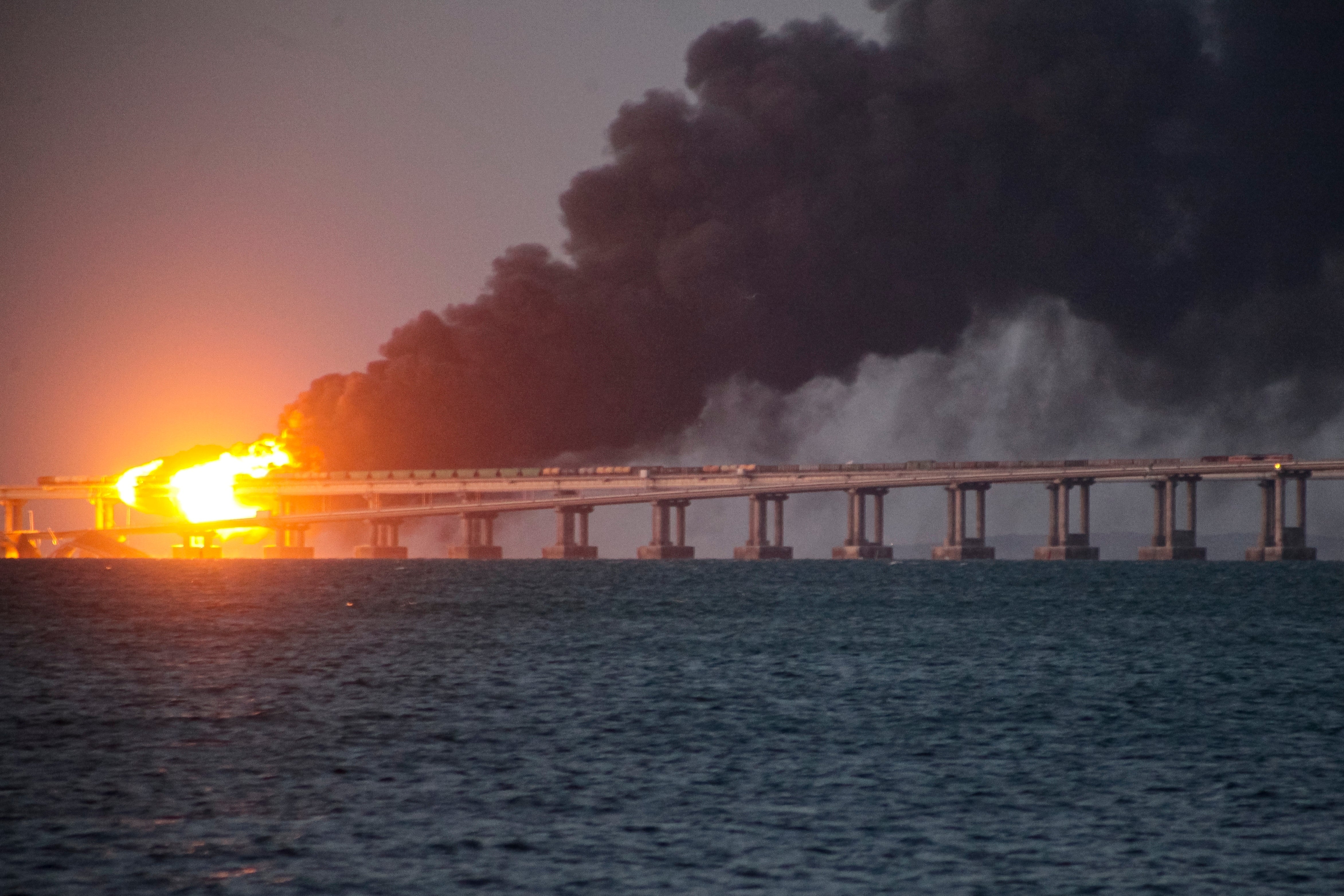 Flame and smoke rise from Crimean Bridge connecting Russian mainland and Crimean peninsula over the Kerch Strait, in Kerch, Crimea